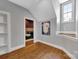 Hallway with hardwood floors and a view into a bedroom, with a window letting in light at 4536 Rustling Woods Dr, Denver, NC 28037