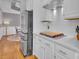 Bright kitchen featuring stainless steel refrigerator, and white countertops and backsplash at 4536 Rustling Woods Dr, Denver, NC 28037