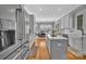Spacious kitchen featuring stainless steel refrigerator, center island, hardwood floors and view to dining at 4536 Rustling Woods Dr, Denver, NC 28037