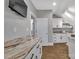 A kitchenette with marble countertops, white cabinets, a stainless-steel sink, and appliances at 4536 Rustling Woods Dr, Denver, NC 28037