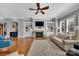 Cozy living room with built-in shelving, a fireplace, hardwood floors, and comfortable seating at 4536 Rustling Woods Dr, Denver, NC 28037