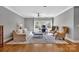 Comfortable living room features hardwood floors, a ceiling fan, and large windows at 4536 Rustling Woods Dr, Denver, NC 28037