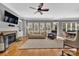 Bright and airy living room with a fireplace, large windows, and hardwood floors at 4536 Rustling Woods Dr, Denver, NC 28037