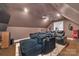 Luxurious movie room featuring comfortable seating, custom lighting, and a ceiling fan at 4536 Rustling Woods Dr, Denver, NC 28037