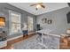 Comfortable home office with natural light, wood floors, ceiling fan, and neutral gray paint at 4536 Rustling Woods Dr, Denver, NC 28037