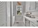 Pantry with white cabinets and granite countertop for storage with a window for natural light at 4536 Rustling Woods Dr, Denver, NC 28037