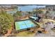 Aerial view showcases the community tennis courts and clubhouse surrounded by landscaping at 4536 Rustling Woods Dr, Denver, NC 28037
