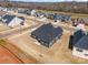 This aerial view shows a navy blue home, new construction, and a brown lawn at 456 Lucky Dr, Concord, NC 28027