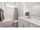 Clean bathroom features a tub with shower curtain, neutral walls, and sleek vanity at 456 Lucky Dr, Concord, NC 28027