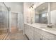 Bright bathroom boasts double vanity, large mirror, and tiled shower with glass door at 456 Lucky Dr, Concord, NC 28027