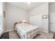 Bright bedroom with natural light from window, closet and a bed with a patterned quilt at 456 Lucky Dr, Concord, NC 28027