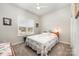 Cozy bedroom featuring a comfortable bed, ceiling fan, and natural light from the window at 456 Lucky Dr, Concord, NC 28027