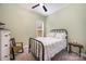 This bedroom has a black metal bed frame, floral bedding, and a window with natural light at 456 Lucky Dr, Concord, NC 28027