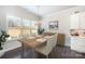 Dining area featuring a large window, chandelier, hardwood floors, and white cabinetry at 456 Lucky Dr, Concord, NC 28027