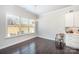 Dining area with large window, chandelier, hardwood floors, and white cabinetry at 456 Lucky Dr, Concord, NC 28027