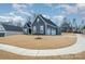 Side exterior view featuring a blue siding with a two car garage, nice landscaping, and a sidewalk at 456 Lucky Dr, Concord, NC 28027