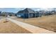 This exterior view shows a navy blue home with a three car garage and a concrete patio at 456 Lucky Dr, Concord, NC 28027