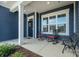 Inviting front porch featuring seating, a welcoming wreath, and classic design elements at 456 Lucky Dr, Concord, NC 28027