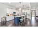 Modern kitchen featuring white cabinets, stainless steel appliances, and a blue island with barstool seating at 456 Lucky Dr, Concord, NC 28027