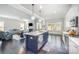 Modern kitchen flowing to a living space with stainless steel appliances and a large island with barstool seating at 456 Lucky Dr, Concord, NC 28027