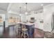 Bright kitchen featuring a blue island with seating and hardwood floors at 456 Lucky Dr, Concord, NC 28027