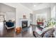 Cozy living room featuring a fireplace, large windows, and beautiful hardwood floors at 456 Lucky Dr, Concord, NC 28027