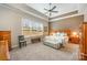 Spacious main bedroom featuring a tray ceiling, ceiling fan, and large window at 456 Lucky Dr, Concord, NC 28027