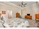 Spacious main bedroom featuring a tray ceiling, ceiling fan, and carpeted floors at 456 Lucky Dr, Concord, NC 28027