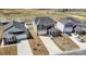 Aerial view of a two-story home with well-maintained landscaping, a two-car garage, and a nearby community at 5013 Dunsford Dr, Denver, NC 28037