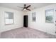 Bedroom with neutral walls, carpet, ceiling fan, and a bookshelf at 5013 Dunsford Dr, Denver, NC 28037