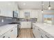 Bright kitchen featuring white cabinets, stainless steel appliances, a center island, and a tile backsplash at 5013 Dunsford Dr, Denver, NC 28037