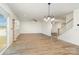 Bright living room featuring a sliding glass door, wood floors, and stairs leading to the second floor at 5013 Dunsford Dr, Denver, NC 28037