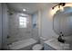 Modern bathroom featuring tile surround tub, updated vanity, and modern lighting at 621 Cauthen St, Rock Hill, SC 29730