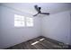 An empty, bright bedroom features a modern ceiling fan and sunlight streaming through the window at 621 Cauthen St, Rock Hill, SC 29730