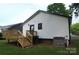 Home's exterior showcasing a wooden deck and steps, set against a backdrop of green grass and white siding at 621 Cauthen St, Rock Hill, SC 29730