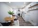 Bright eat-in kitchen with stainless steel appliances, white cabinets, new countertops and modern flooring at 621 Cauthen St, Rock Hill, SC 29730