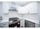 Modern kitchen features new stainless steel appliances and white cabinets with dark, modern handles at 621 Cauthen St, Rock Hill, SC 29730