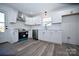 Bright kitchen boasts stainless steel appliances, white cabinetry, tile backsplash, and durable new floors at 621 Cauthen St, Rock Hill, SC 29730