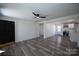 Bright living room with a modern ceiling fan, new flooring, and an open doorway to the kitchen area at 621 Cauthen St, Rock Hill, SC 29730