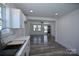 Open floor plan showing new kitchen with white cabinets that flows into the living room featuring new hard surface floors at 621 Cauthen St, Rock Hill, SC 29730