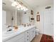 Bathroom features a double sink vanity, neutral walls, with decorative accents and a framed mirror at 6635 Vlosi Dr, Charlotte, NC 28226