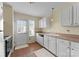 Functional kitchen with white cabinetry, essential appliances, and a doorway leading to the outdoors, perfect for cooking at 6635 Vlosi Dr, Charlotte, NC 28226