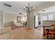 Spacious living room with a chandelier and hard wood floors is connected to the kitchen space at 6635 Vlosi Dr, Charlotte, NC 28226