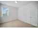 Bright, carpeted bedroom featuring a window with blinds and double door closet at 758 Waterscape Ct, Rock Hill, SC 29730