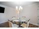 Cozy dining area with a glass table, four chairs, and a modern chandelier for a comfortable atmosphere at 758 Waterscape Ct, Rock Hill, SC 29730