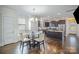 Sunlit dining area features built-in seating and complements a modern kitchen with stainless steel appliances at 758 Waterscape Ct, Rock Hill, SC 29730