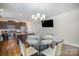 Spacious dining area featuring a round table, dark wood floors, and modern stainless steel kitchen appliances at 758 Waterscape Ct, Rock Hill, SC 29730