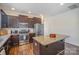 Spacious kitchen with dark wood cabinets, granite countertops, stainless steel appliances, and a central island at 758 Waterscape Ct, Rock Hill, SC 29730