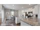 Stylish kitchen with white cabinets, an island, stainless steel appliances, and an adjacent dining area at 8051 Plymouth Dr, Sherrills Ford, NC 28673