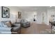 Living room with carpet flooring, neutral tones, and a loft-like layout at 8051 Plymouth Dr, Sherrills Ford, NC 28673